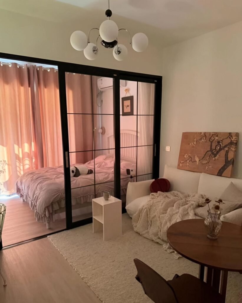 Black Steel Sliding Glass Doors to Separate Bedroom From Living Area
