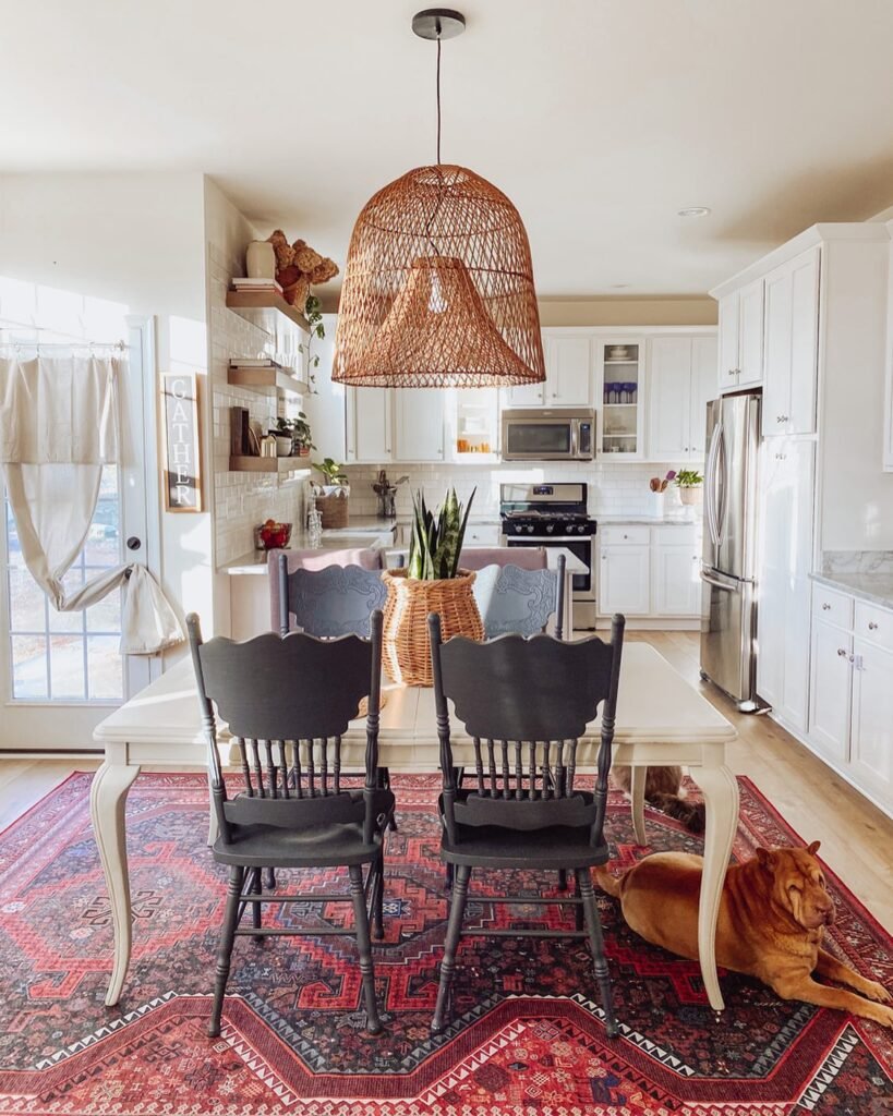 Boho Dining Room With Mixed Chairs and Statement Pendant