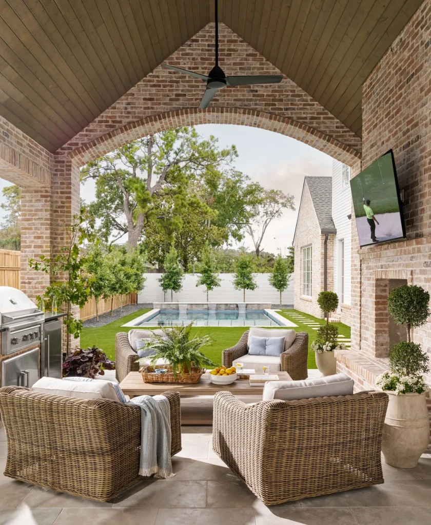 Brick Arch Covered Patio with Wicker Lounge Set, Outdoor TV, and Pool View