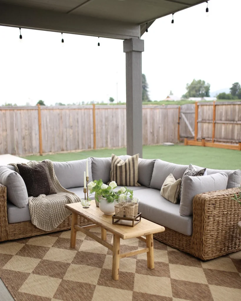 Covered Patio with Wicker Sectional, Diamond Rug, and Backyard Views