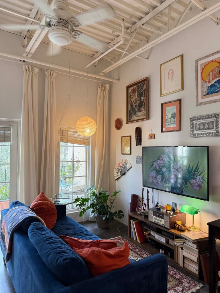 Eclectic Studio With Exposed Ceiling Beams and Gallery Wall Layout