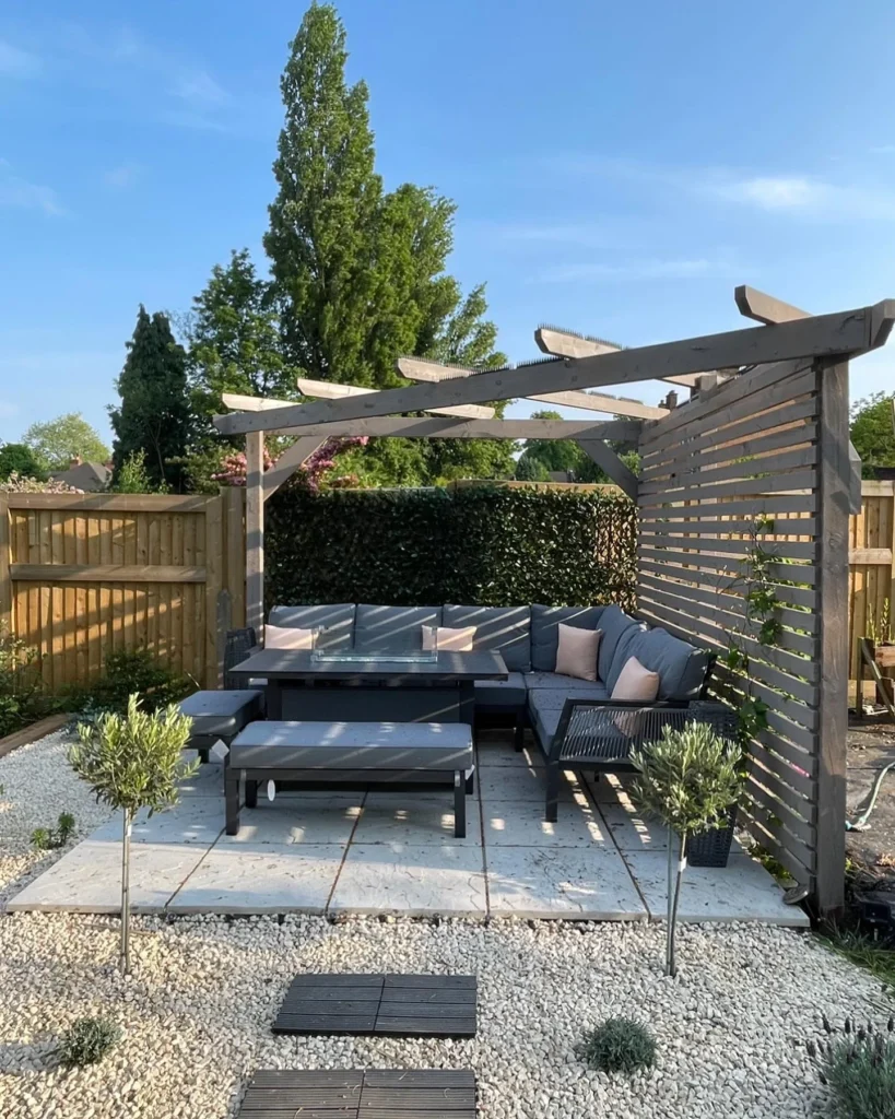 Grey Garden Lounge with Rustic Pergola, Fire Table, and Gravel Surround