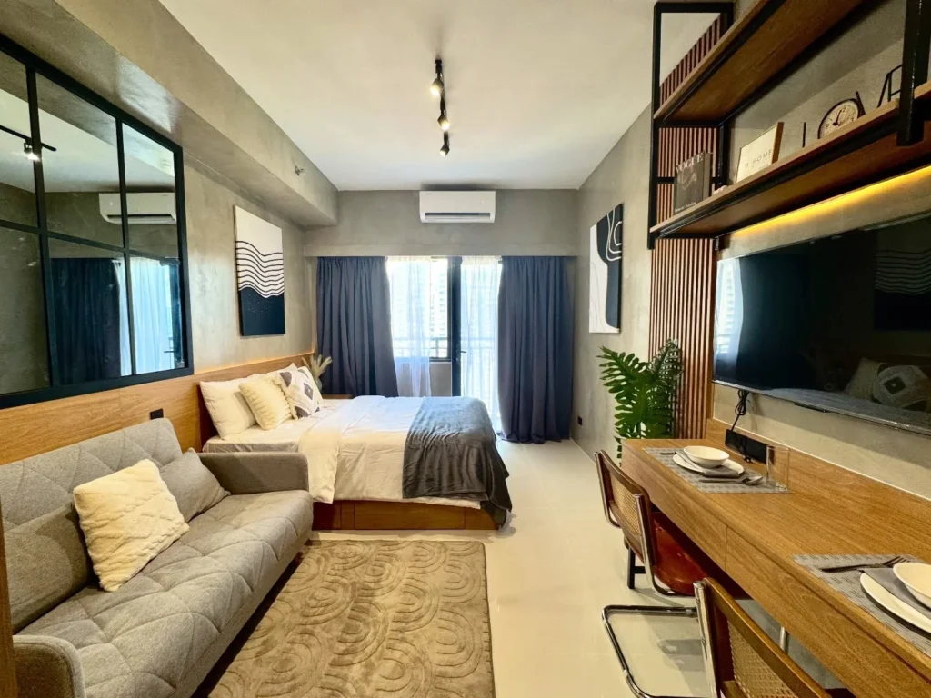 Industrial Studio With Concrete Walls and Built-In Wood Entertainment Wall
