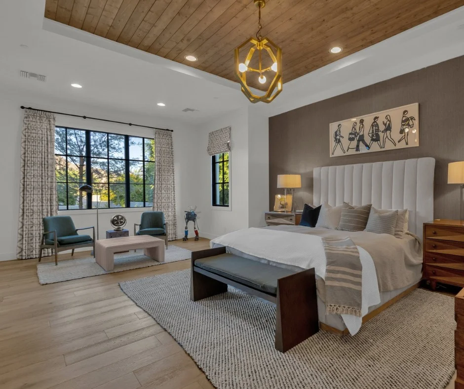 Luxury Master Bedroom With Wood Plank Ceiling and Tall Channel Headboard