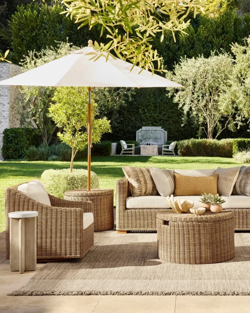 Neutral Wicker Garden Lounge with Market Umbrella and Manicured Garden Views