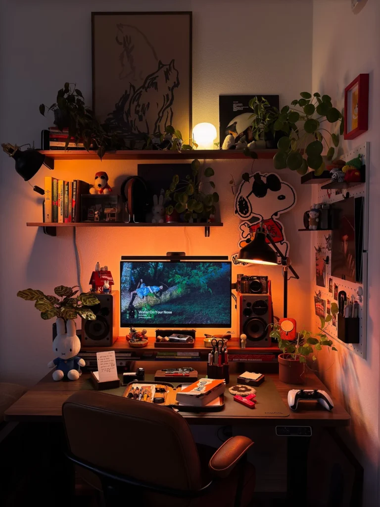 Warm Amber Desk Setup with Snoopy Collectibles and Cozy Night Vibes